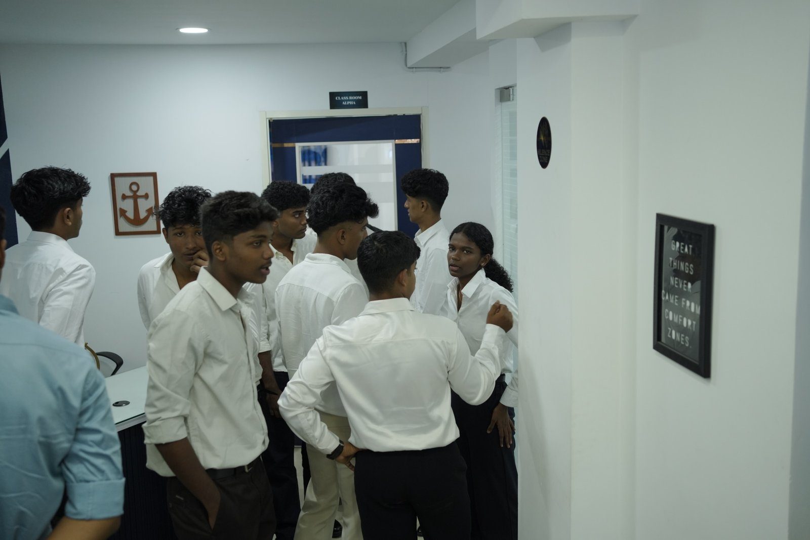 NavPath students in white shirts talking outside Classroom Alpha at the Kottayam campus