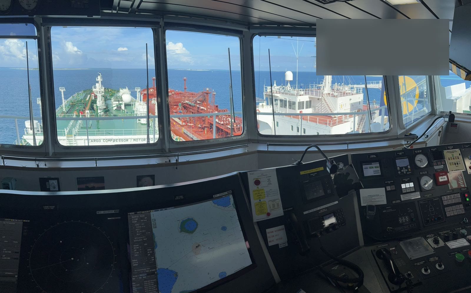 Two ships alongside each other during a ship-to-ship transfer at sea